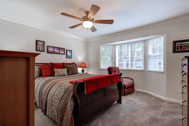 carpeted bedroom with a ceiling fan, crown molding, and baseboards