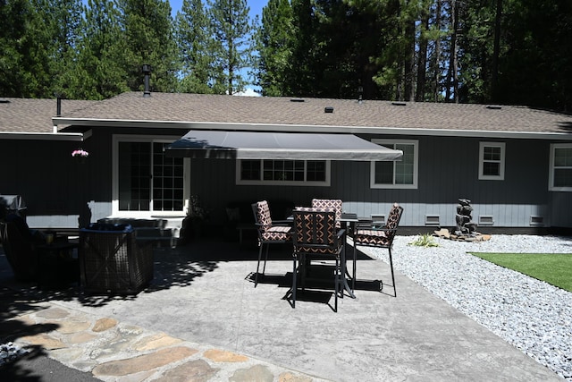 37105 Sapphire Rd, Burney, CA 96013 - rear view of house with crawl space, a patio area, roof with shingles, and outdoor dining space