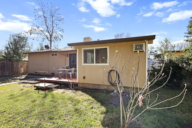 3235 Sharon Ave, Anderson, CA 96007 - rear view of house with a lawn, stucco siding, fence, and a deck