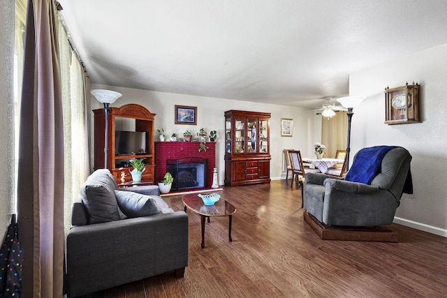 3235 Sharon Ave, Anderson, CA 96007 - living room with baseboards, dark wood-type flooring, and a brick fireplace