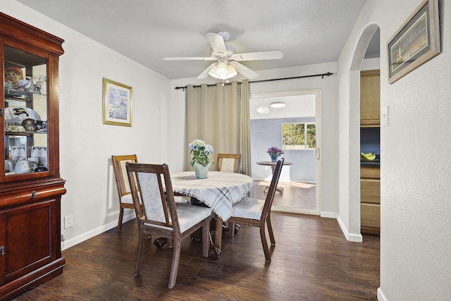 3235 Sharon Ave, Anderson, CA 96007 - dining room with baseboards, dark wood-style floors, arched walkways, and a ceiling fan