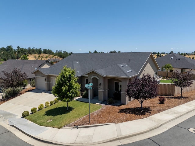 819 Bellagio Ter, Redding, CA 96003 - view of front of property featuring stucco siding, concrete driveway, an attached garage, a shingled roof, and a residential view