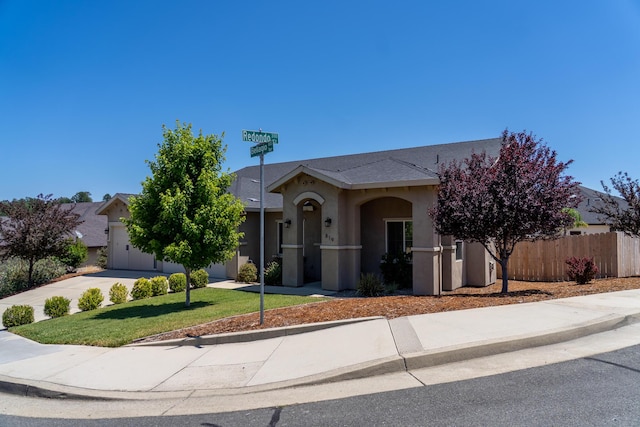 819 Bellagio Ter, Redding, CA 96003 - view of front facade with stucco siding and concrete driveway