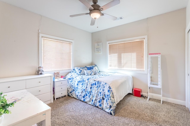 bedroom with baseboards, ceiling fan, visible vents, and light carpet