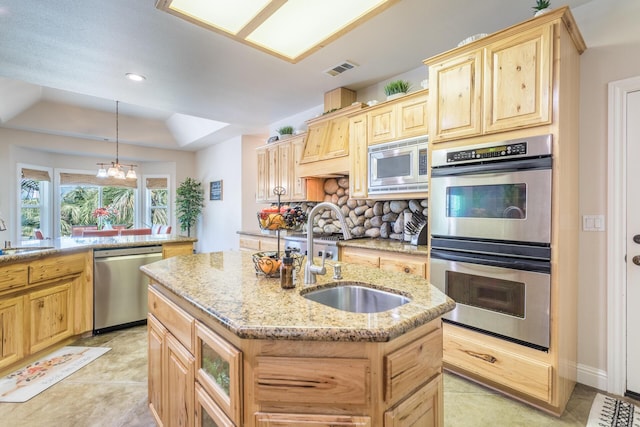 kitchen featuring backsplash, a sink, stainless steel appliances, and light brown cabinetry