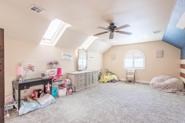 playroom with carpet floors, visible vents, and lofted ceiling with skylight