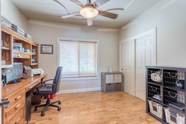 office featuring baseboards, light wood-style floors, and ceiling fan