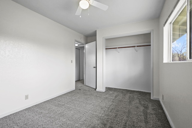 unfurnished bedroom with a closet, carpet flooring, ceiling fan, and baseboards