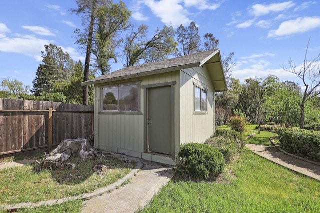 view of outbuilding featuring fence and an outdoor structure
