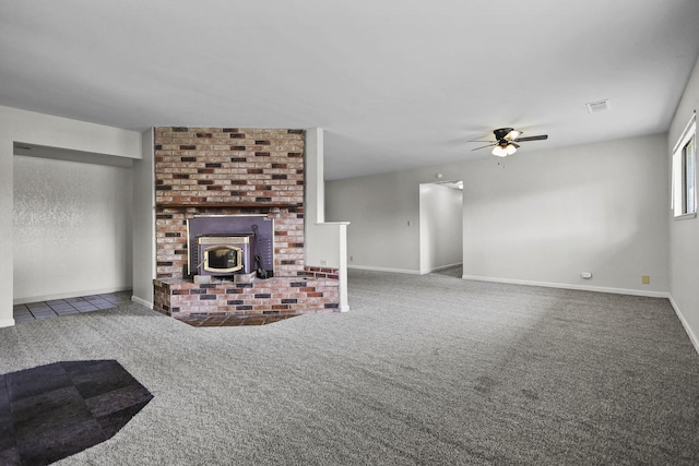 unfurnished living room featuring baseboards, carpet flooring, visible vents, and a ceiling fan