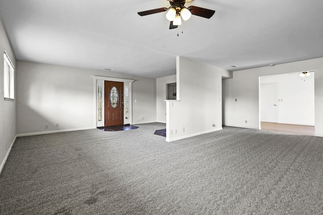 unfurnished living room featuring baseboards, ceiling fan, visible vents, and carpet floors