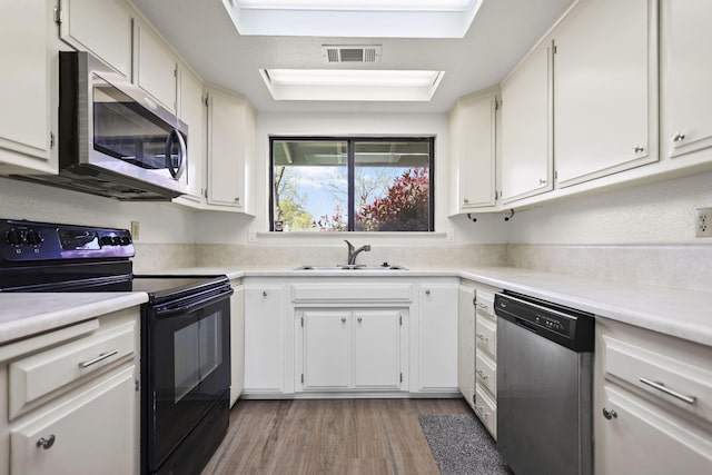 kitchen with light countertops, a sink, stainless steel appliances, and visible vents