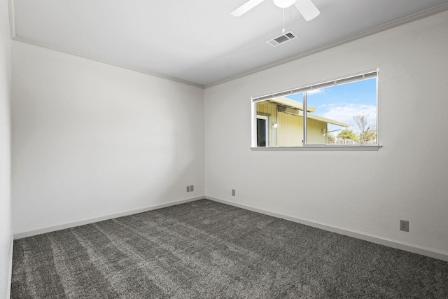 unfurnished room with crown molding, dark colored carpet, baseboards, visible vents, and a ceiling fan