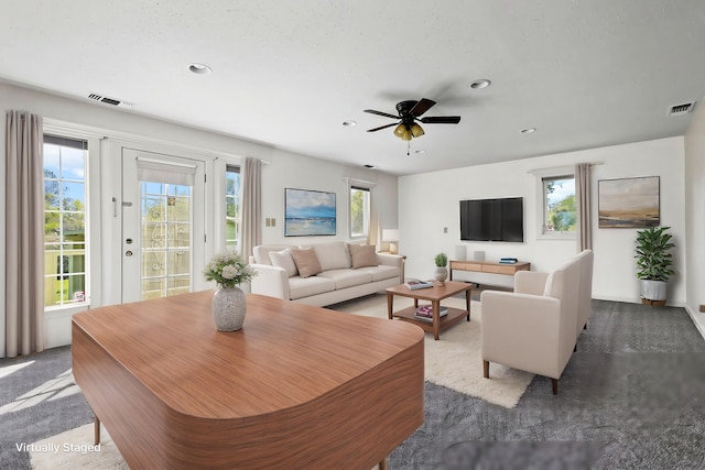 carpeted living area with recessed lighting, ceiling fan, and visible vents