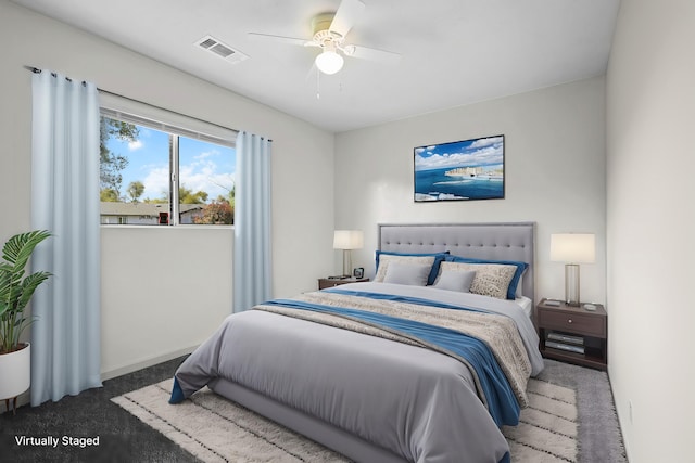 bedroom featuring baseboards, carpet floors, visible vents, and a ceiling fan