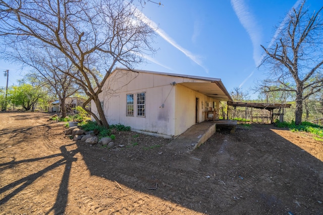 view of home's exterior featuring a carport