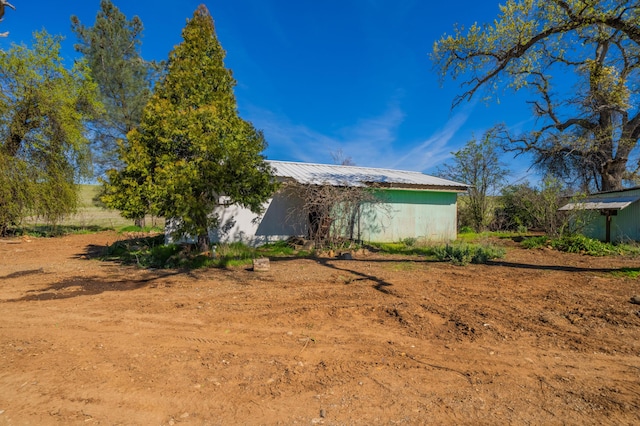 exterior space featuring metal roof and an outdoor structure