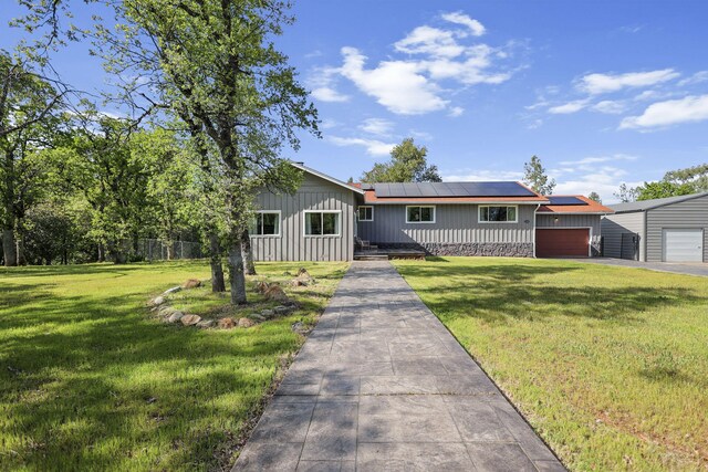 17622 China Gulch Dr, Anderson, CA 96007 - view of front of home with a front lawn, solar panels, board and batten siding, and driveway