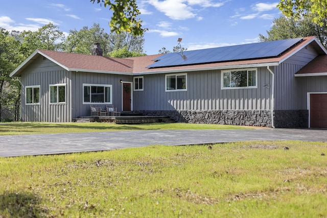 17622 China Gulch Dr, Anderson, CA 96007 - ranch-style home featuring solar panels, a front yard, a garage, and board and batten siding