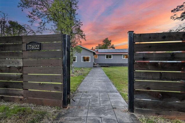 17622 China Gulch Dr, Anderson, CA 96007 - exterior space featuring a lawn, fence, and roof mounted solar panels