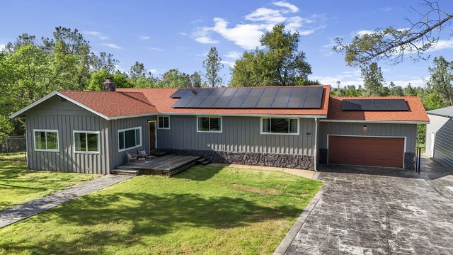 17622 China Gulch Dr, Anderson, CA 96007 - ranch-style home featuring roof mounted solar panels, driveway, a front yard, and an attached garage