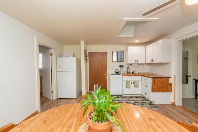 493 Main St, Weaverville, CA 96093 - kitchen featuring white appliances, white cabinets, light wood-style flooring, wood counters, and recessed lighting