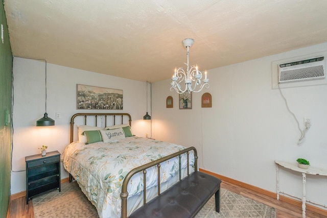 493 Main St, Weaverville, CA 96093 - bedroom with wood finished floors, a chandelier, and a wall mounted AC