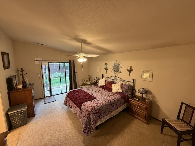 carpeted bedroom with a textured ceiling, vaulted ceiling, ceiling fan, and access to outside