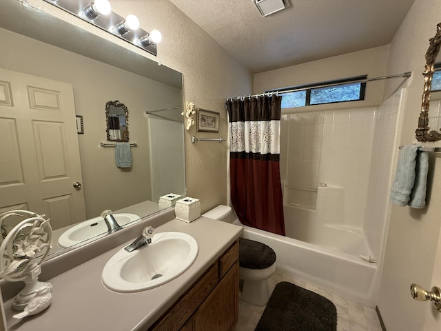 bathroom featuring vanity, toilet, a textured wall, visible vents, and shower / bath combo