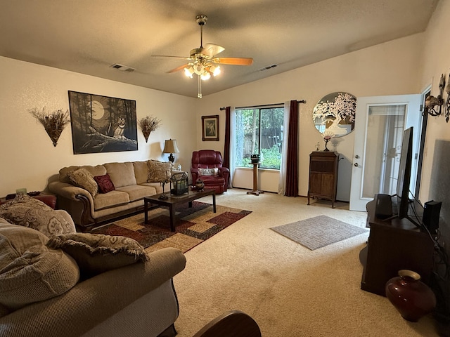 living room featuring light carpet, visible vents, ceiling fan, and lofted ceiling