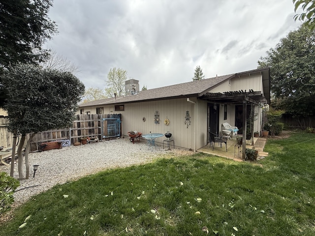 back of house featuring fence, a patio, central AC unit, a pergola, and a lawn