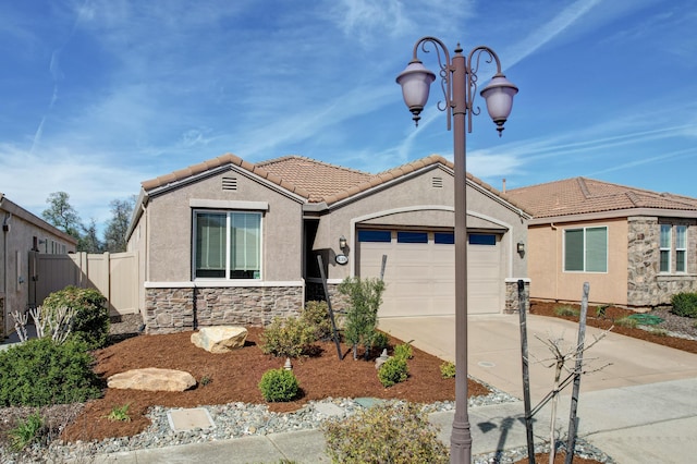 view of front facade featuring an attached garage, a tile roof, stucco siding, and driveway