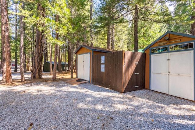 view of shed featuring fence