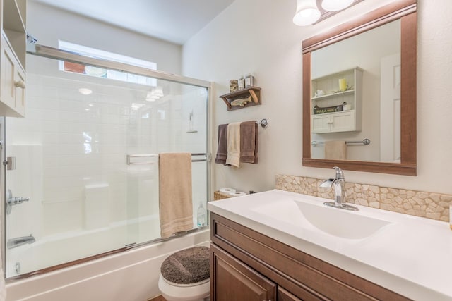 bathroom with vanity, toilet, and enclosed tub / shower combo