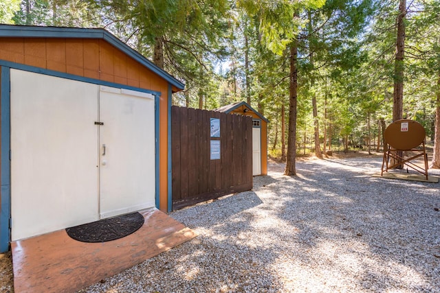 view of shed with fence