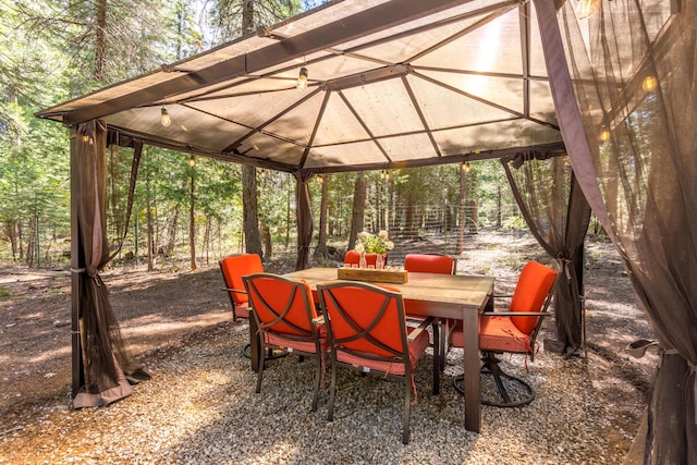 view of patio / terrace with outdoor dining area and a gazebo
