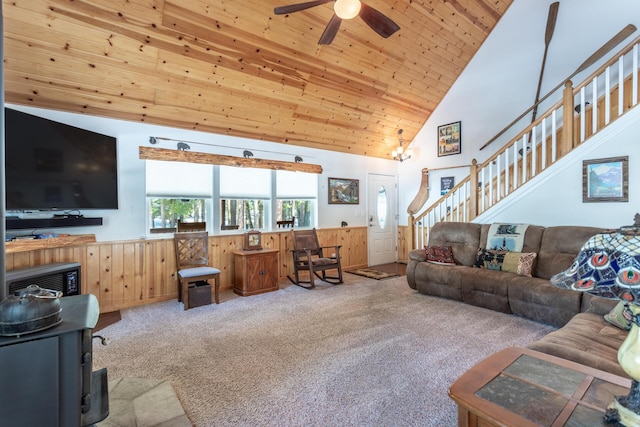 carpeted living area with high vaulted ceiling, wooden ceiling, ceiling fan, and stairway