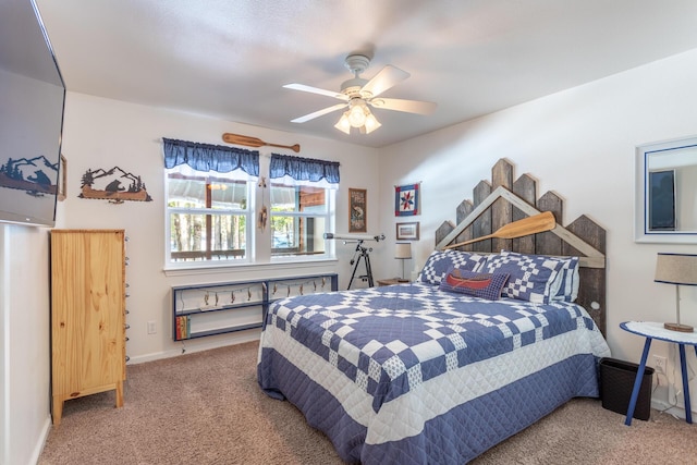 carpeted bedroom featuring a ceiling fan and baseboards