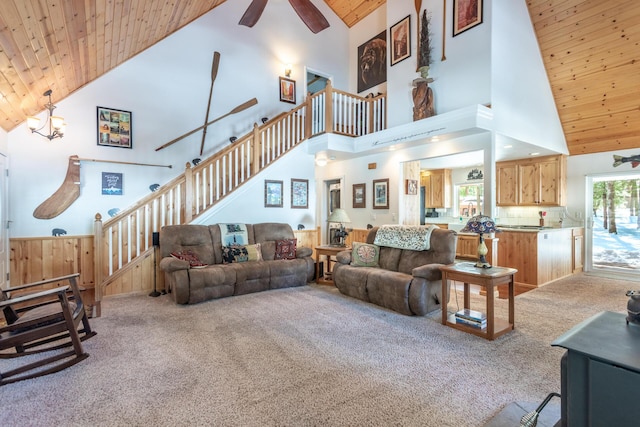 carpeted living room featuring stairs, ceiling fan, high vaulted ceiling, and wood ceiling
