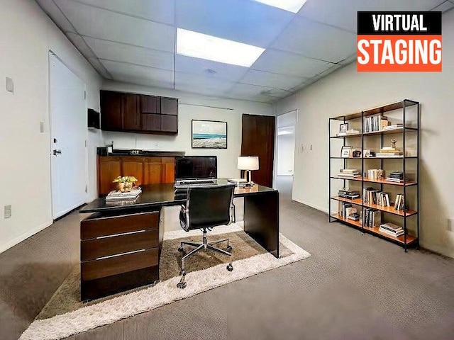 office with baseboards and a paneled ceiling