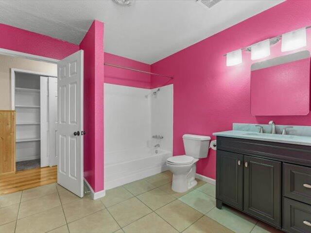 926 Cortina Dr, Orland, CA 95963 - full bath featuring baseboards, toilet, tile patterned floors, vanity, and shower / bathtub combination