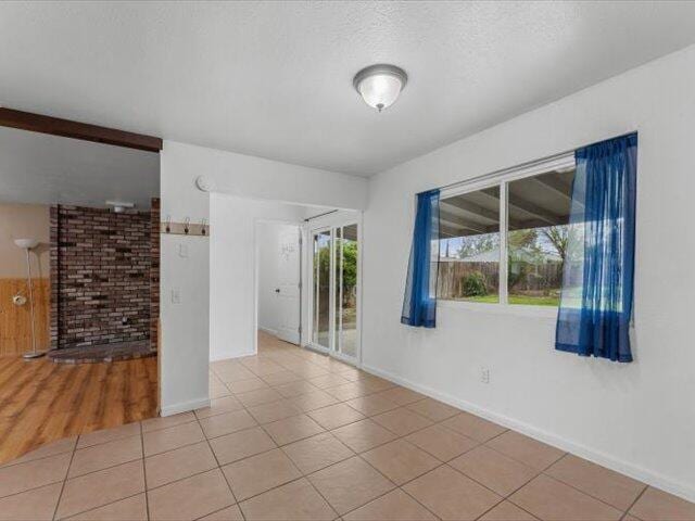 926 Cortina Dr, Orland, CA 95963 - spare room featuring light tile patterned floors, baseboards, and a textured ceiling