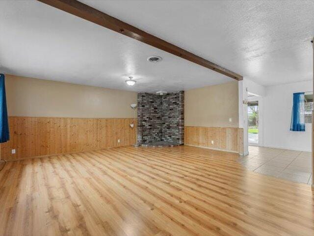 926 Cortina Dr, Orland, CA 95963 - unfurnished room featuring visible vents, wood finished floors, wainscoting, and beam ceiling
