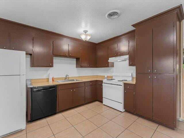 926 Cortina Dr, Orland, CA 95963 - kitchen featuring light countertops, visible vents, white appliances, under cabinet range hood, and a sink