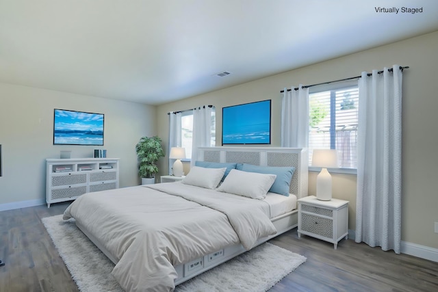 1680 Morningsun Dr, Redding, CA 96002 - bedroom featuring multiple windows, baseboards, and wood finished floors