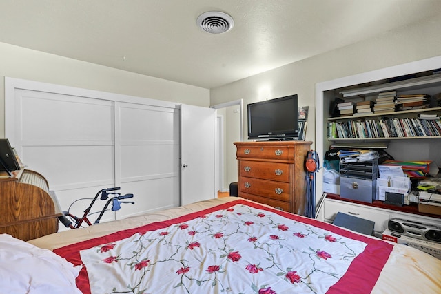 bedroom with visible vents and a closet