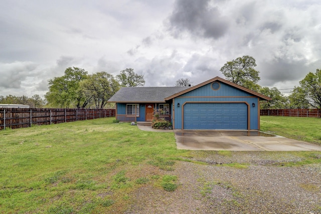 view of front facade with fence, driveway, a front yard, and a garage