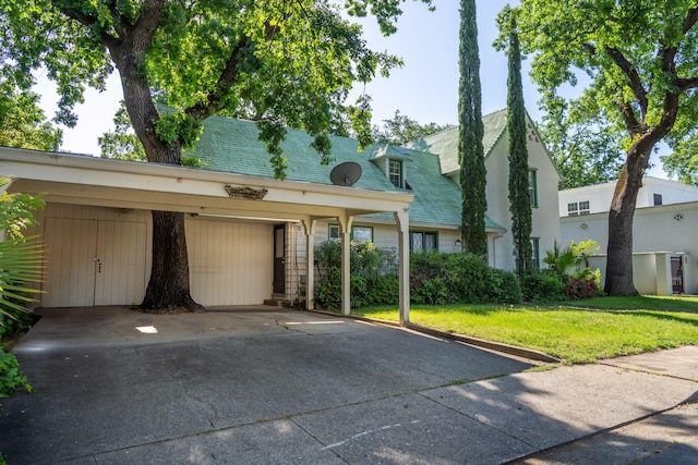 view of front facade with a carport and a front lawn