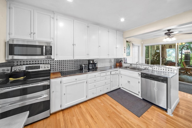 kitchen featuring a sink, appliances with stainless steel finishes, and white cabinetry