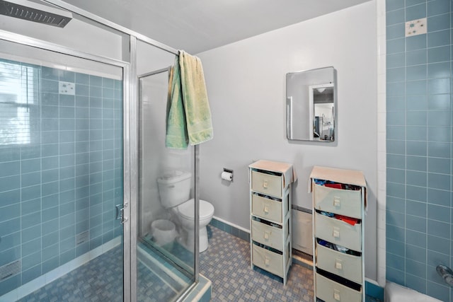 bathroom with toilet, a stall shower, and tile patterned flooring